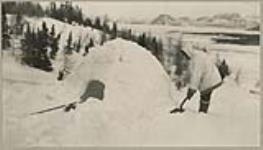 [John Voisey building an Iglu (snow house)]. [between 1921-1922]