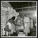 At Tashme young Japanese girls work in the shoyu and misa factory making the well known oriental sauce and paste--integral parts of their diet. [1945/06/16-1945/06/28]