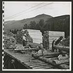 Piles of railway ties at the Lemon Creek sawmill. [2/2]. [1945/06/16-1945/06/28]