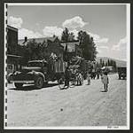 Japanese who wish to be re-atriated are moved to settlements with others of the same mind, the Canadian government paying their way back to Japan. Trucks are used for short trips, buses for long: picture taken at Slocan City. [1945/06/16-1945/06/28]