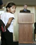 [A young girl looks at the camera while Prime Minister Stephen Harper delivers a speech at the Northwest Territories Legislature in Yellowknife] 17 August 2006