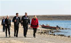 [Prime Minister Stephen Harper and his wife Laureen Harper, joined by Jamie Cassels, President of the University of Victoria, and Kate Moran, CEO of Ocean Networks Canada, enjoy the scenery at the wharf in Cambridge Bay, Nunavut during his ninth annual tour of Canada's northern territories] 23 August 2014