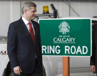 [Prime Minister Stephen Harper walks past a road sign before announcing a major extension to Calgary's Ring Road in Calgary, Alberta] 22 May 2009