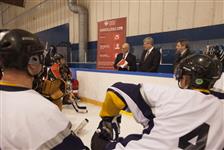 [Prime Minister Stephen Harper chats with Dr. Doug Clement, Chair of the Heart and Stroke Foundation, and heart attack survivor Robin Biggs at the Canlan Ice Sports Agriplace in Saskatoon, Saskatchewan] 21 February 2013