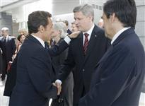 [French President Nicolas Sarkozy greets Prime Minister Stephen Harper at the Normandy American Cemetery, Omaha Beach in France] 6 June 2009