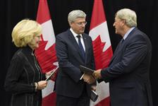 [Prime Minister Stephen Harper receives the Ukrainian Election Observer Report from Senator Raynell Andreychuk and Mike Harris while in Toronto, Ontario] 11 September 2014
