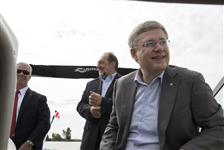 [Prime Minister Stephen Harper and Minister Denis Lebel make their way by boat to La Place de La Traversée in Roberval, Quebec] 25 June 2014