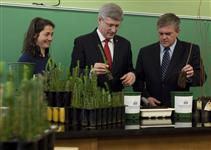 [Prime Minister Stephen Harper and David Alward, Premier of New Brunswick, plant seeds with forestry student Audrey Labonté at the Université de Moncton in Edmundston, New Brunswick] 11 May 2012