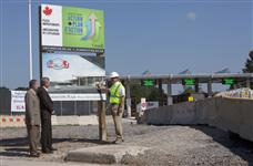 [Prime Minister Stephen Harper and Justice Minister and Attorney General Rob Nicholson talk with senior project manager Chris Hawkins at the construction site of the Queenston Plaza border crossing in Niagara-on-the-Lake, Ontario] 3 September 2009