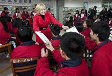 [Laureen Harper hands out translated copies of Anne of Green Gables at the Huamei Bond International School in Guangzhou, China] 4 February 2012
