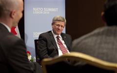 [Prime Minister Stephen Harper meets with Sean Palter and Aly Verjee, Canadian participants in the Young Atlanticists Program, before the start of the NATO Summit in Lisbon, Portugal] 19 November 2010