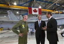 [Prime Minister Stephen Harper speaks to CF-18 fighter jet pilot Major Daniel Dionne and Minister Peter MacKay in Mirabel, Quebec] 1 September 2010