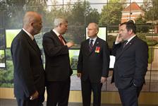 [Prime Minister Stephen Harper chats with MP Dave Van Kesteren and Ministers Erin O'Toole and Jason Kenney after an event at Holten Canadian War Cemetery in the Netherlands] 4 May 2015