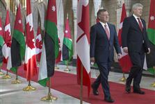 [Prime Minister Stephen Harper walks down the Hall of Honour on Parliament Hill with His Majesty King Abdullah of Jordan following discussions about the current conflict with ISIS] 29 April 2015