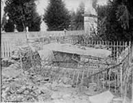 Robbing the dead French- One of the damaged graves at Roye which has been opened and destroyed by the Huns May, 1917.