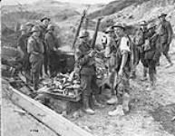 A badly wounded Canadian drinking hot coffee at Soup Kitchen 100 yards from Boche lines during push on Hill 70. Aug. 1917 Aug., 1917.