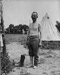 Boche prisoner pleased to get his boots off. July, 1917 July, 1917.