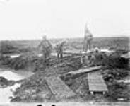 Canadian Pioneers laying trench mats over mud. Battle of Passchendaele November, 1917.