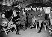 Officers of the Canadian Motor Machine Gun Brigade having a musical evening. April, 1918 Avril 1918