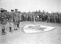 General Currie with Generals Macdonell and Loomis inspecting model of 2nd Infantry Brigade Badge made by men of Brigade. May, 1918 MAY, 1918