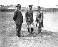 Premier Norris and Major-General Macdonell talking to a Pipe Major at a Sports Meet. June, 1918 June, 1918.