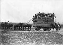 Circus van drawn by eight mules with band up. Canadian Curcys behing the Lines. May, 1918 MAY, 1918