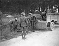 Machine Gunners placing enemy wounded in truck. Battle of Amiens. August, 1918 August 1918.