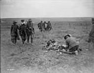 Canadian Stretcher bearer redressing a wound. Advance East of Arras. Aug. 1918 Aug., 1918.