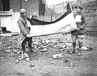 The German flag which was taken down from the Hotel de Ville, Valenciennes, by some Canadian Artillery Officers. Nov. 1918 Nov. 1918.