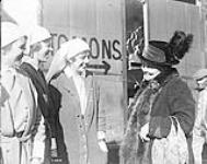 Three Canadian Sisters in Valenciennes, Nov. 10th, 1918, talking to a civilian November 10, 1918.