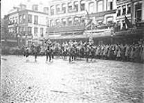 General Sir Arthur Currie, General Loomis and Officers in Grand Place, Mons, November 11th, 1918, taking the salute of the March past November 11, 1918.