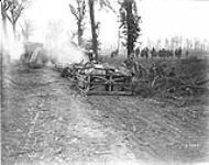Tanks going forward to attack Germans in wood, Infantry on right; prisoners are seen coming in August 9, 1918.
