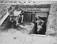 Lt.-Col. Moshier, Capt. Grant and Capt. Turnbull, 11th Field Ambulance, outside captured German dug-out. August, 1918 August, 1918.