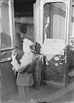A Canadian looking at a second class German carriage from which the Germans cut the coverings of the seats before departing from Mons. November, 1918 November 1918.