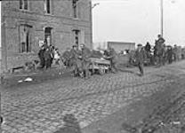 German prisoners captured by Canadians near Mons, pull carts containing civilians' goods. November, 1918 November 1918.