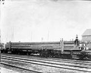 Shipping large timber from Vancouver : Grant Firs 18 x 18 x 70 ft, using 3 flat cars to transport 1868-1923