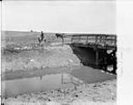 Bridge across main canal, South of Langdon showing Hull's camp in distance [Western Irrigation Block] - (No.) 74 (C.P.R. (Canadian Pacific Railway)) 1868-1923