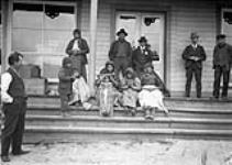 [Group of Gitxsan, waiting at a doctor office, Hazelton, British Columbia] Group of Indigenous people [between September 20-October 21, 1901].