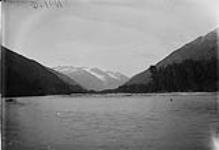 (Canada Alaska Boundary) Looking up Dyea Pass from trail at first bridge, 1897