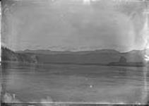 (Canada Alaska Boundary) Looking down the Yukon, Old woman rock on right side and old man rock opposite on left side, 1895