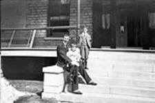 Man and boys on back porch of Rideau Hall n.d.