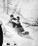Composite photograph of a man and a woman tobogganing n.d.