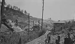 Surface Plant of Sullivan Mine: Compressor in foreground ore crusher & ore bins in background Kimberley, B.C Aug. 1927