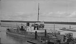 M.S. "Radium King" with barge tied up at Ft. Smith, N.W.T. Aug. 1937