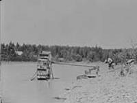 Snipers using water wheels - John Miszzak operates a water wheel outfit, Quesnel River, B.C 1938