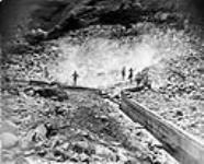 Blasting loose rocks at Bullion: - After 40 secs. - 1st man's splitter is finished etc., Quesnel River, B.C 1938