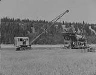 Gravel Machine Operations: - General view of excavator dumping into separator unit, Fraser River, 5 miles North of Quesnel, B.C 1938