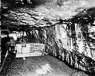 Undercutting a coal seam, Drumheller, Alta