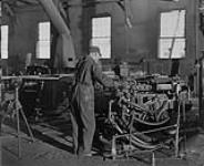 Hollinger Mine - Steel Sharpening Shop - Ingersoll Rand Steel sharpening machine in action. Timmins, Ontario 1936