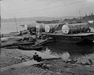 Barges unloading at Yellowknife wharf. Great Slave Lake, N.W.T